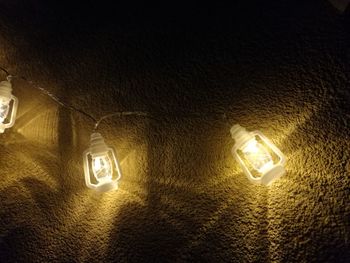 Low angle view of illuminated light on wall
