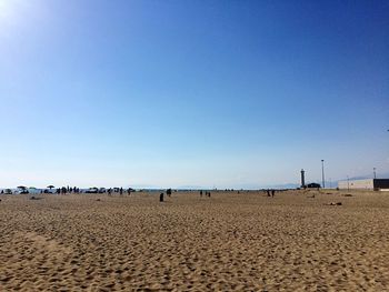 Scenic view of beach against clear blue sky