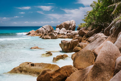 Rocks on beach against sky