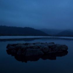 Scenic view of calm lake against sky