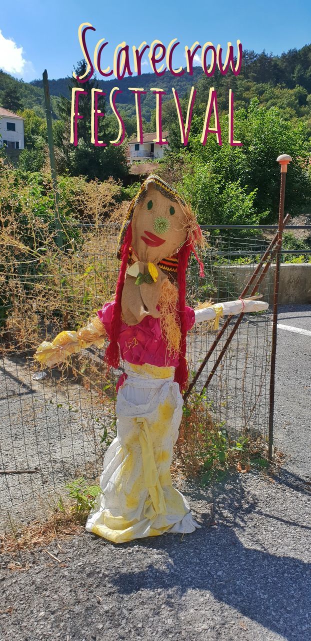 FULL LENGTH OF GIRL STANDING BY TREE