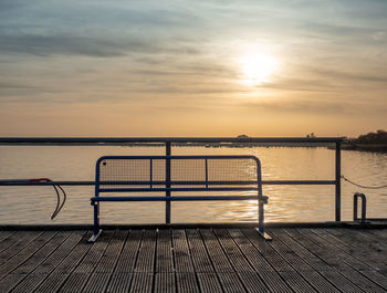 Empty bench on ferry harbor pier bridge at coast of island of ruegen, germany. popular sea bridge