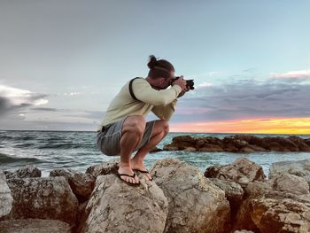 Rear view of woman standing on beach