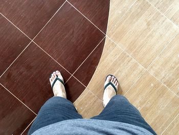 Low section of woman standing on tiled floor