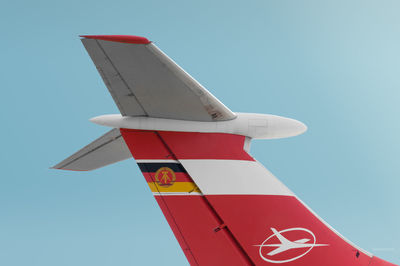 Low angle view of airplane wing against clear sky