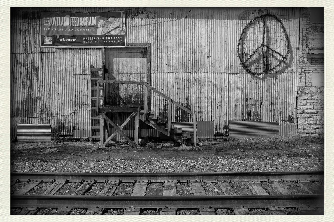 transfer print, auto post production filter, architecture, built structure, text, western script, railroad station, transportation, metal, rail transportation, communication, indoors, railroad track, day, building exterior, no people, old, non-western script, graffiti, railing