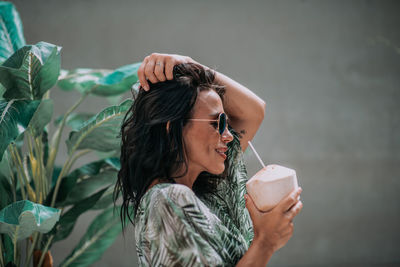 Portrait of young woman drinking water