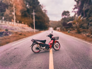 Man riding toy car on road