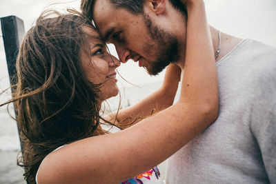 Portrait of young couple kissing outdoors