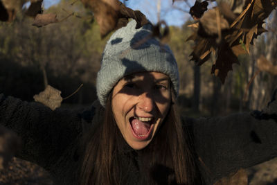 Close-up portrait of young woman wearing hat