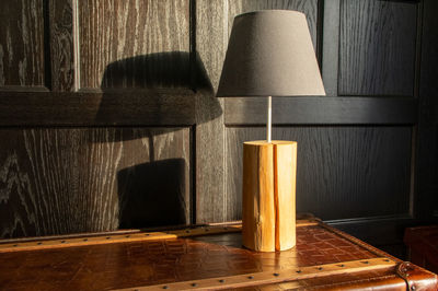 Close-up of illuminated lamp on table at home