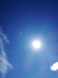 Low angle view of moon against blue sky