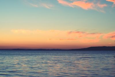 Scenic view of calm sea at sunset