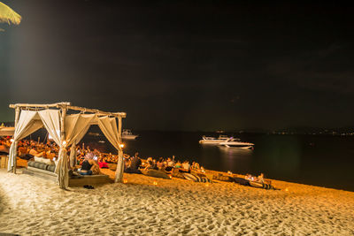 View of illuminated beach at night