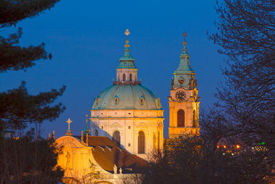 The dome and clock tower of st nicholas cathedral in lesser town against night  sky.