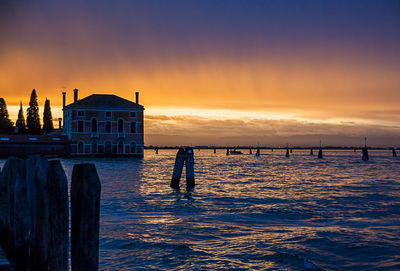 Pier on sea at sunset