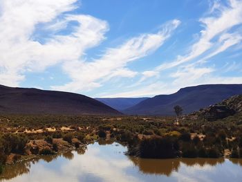 Scenic view of lake and mountains against sky