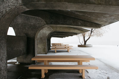 Empty chairs and tables in snow