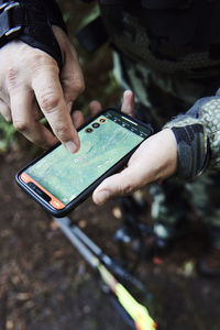 Hunter using gps on his mobile phone