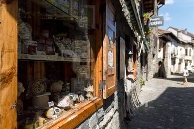 Various objects for sale seen through store window in city