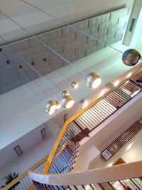 Low angle view of illuminated pendant lights in building