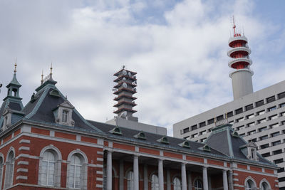 Low angle view of building against cloudy sky