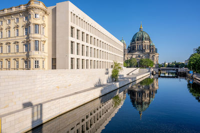 The berliner dom with the reconstructed city palace reflected in the river spree