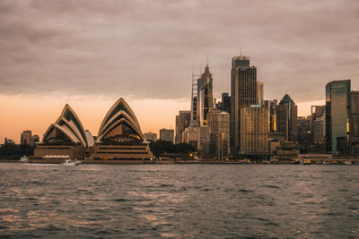 View of city buildings against cloudy sky