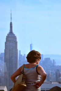 Rear view of woman looking at cityscape