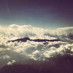 Scenic view of mountains against cloudy sky