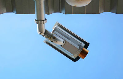 Low angle view of electric lamp against clear sky