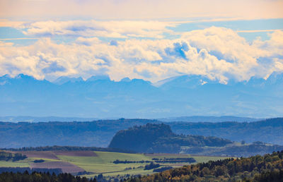 Scenic view of landscape and mountains against sky