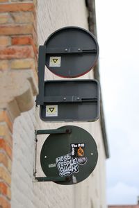 Close-up of information sign against sky