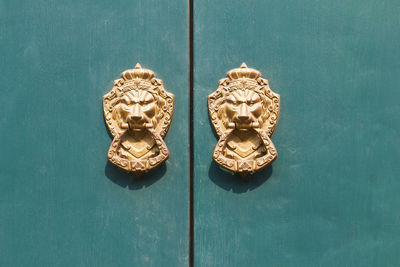 Close-up of knockers on door