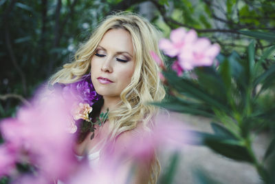Portrait of woman with pink flower