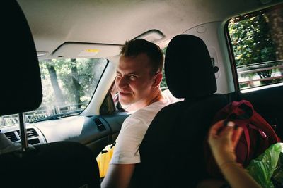 Portrait of man sitting in car