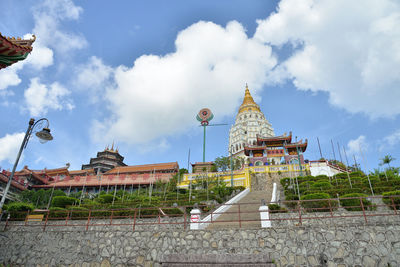 Low angle view of temple against cloudy sky