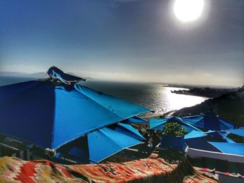 Amusement park by sea against sky