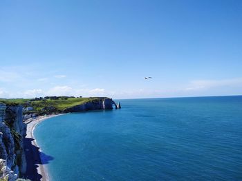 Scenic view of sea against blue sky. etretat, france.