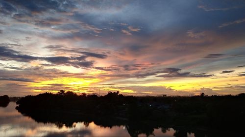 Scenic view of lake against romantic sky at sunset