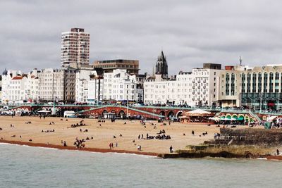 Scenic view of beach against sky in city