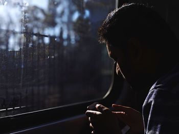 Side view of man using mobile phone