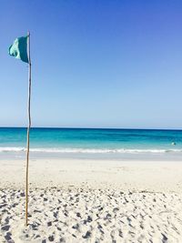 Scenic view of beach against clear blue sky