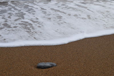 High angle view of surf on beach