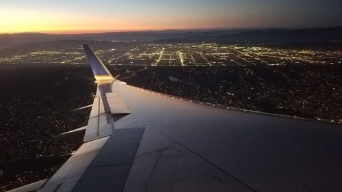 Cropped image of airplane flying over city