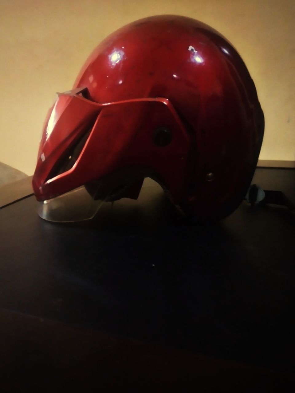 red, helmet, personal protective equipment, indoors, football equipment, headgear, clothing, sports equipment, football helmet, no people, football gear, headwear
