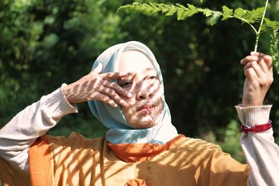 Midsection of man holding plant