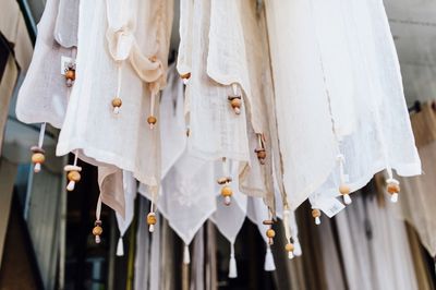 Close-up of white clothes hanging on wood