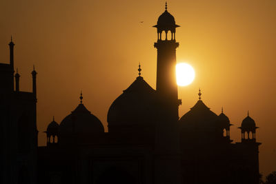 Taj mahal reflected in yamuna river at sunset in agra, india.