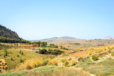 Scenic view of field against clear blue sky